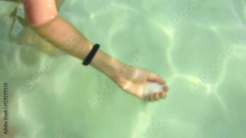 a woman grabbed a sea salt underneath the Dead Sea
