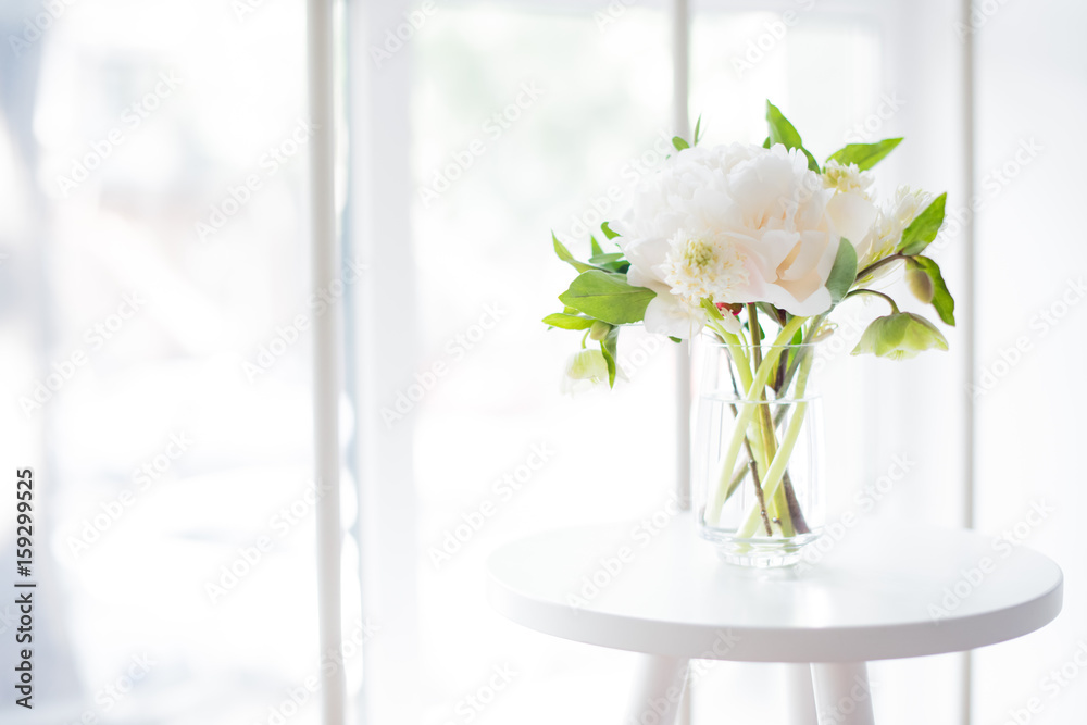 white peony flowers on coffee table in white room interior, brig white peony flowers on coffee table in white room interior, brig