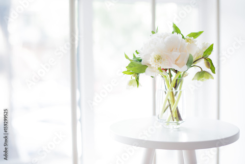 Fototapeta Naklejka Na Ścianę i Meble -  white peony flowers on coffee table in white room interior, brig