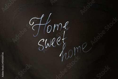 Home Sweet Home inscription on black background