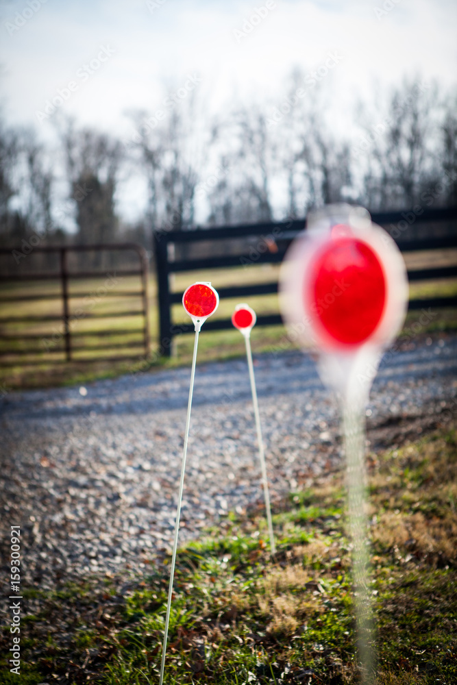 Red warning signs on the side of a gravel road Red warning signs on the side of a gravel road