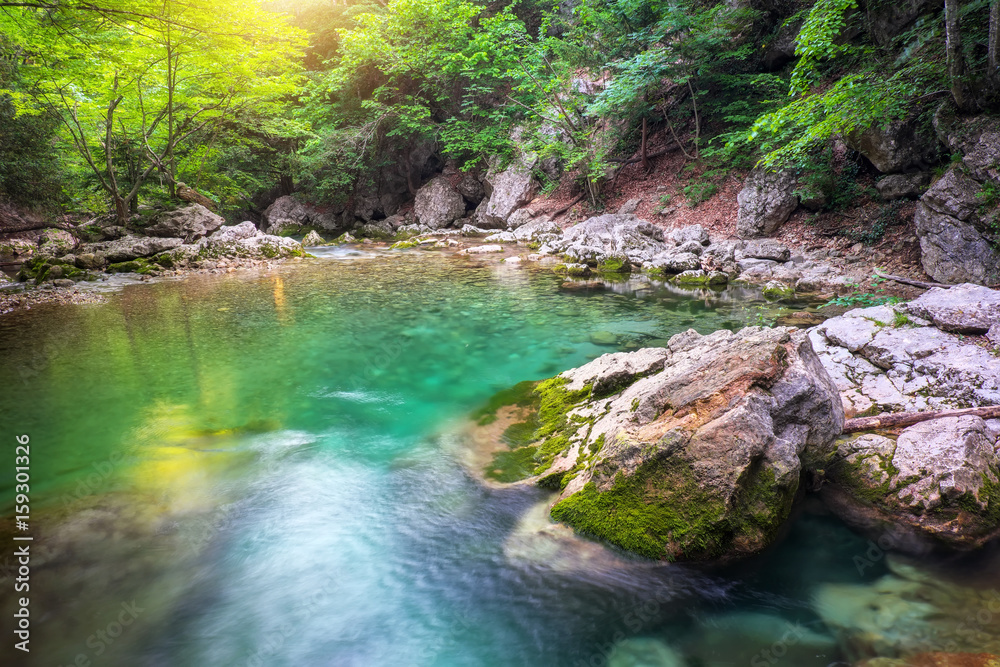 River deep in mountain at summer. Water stream at forest. Composition of nature