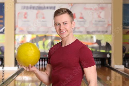 Man with ball in bowling club