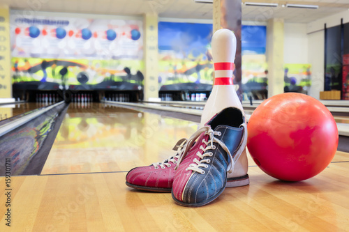 Shoes, pin and ball on floor in bowling club