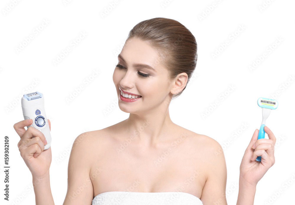 Beautiful young woman with razor and epilator on white background Beautiful young woman with razor and epilator on white background