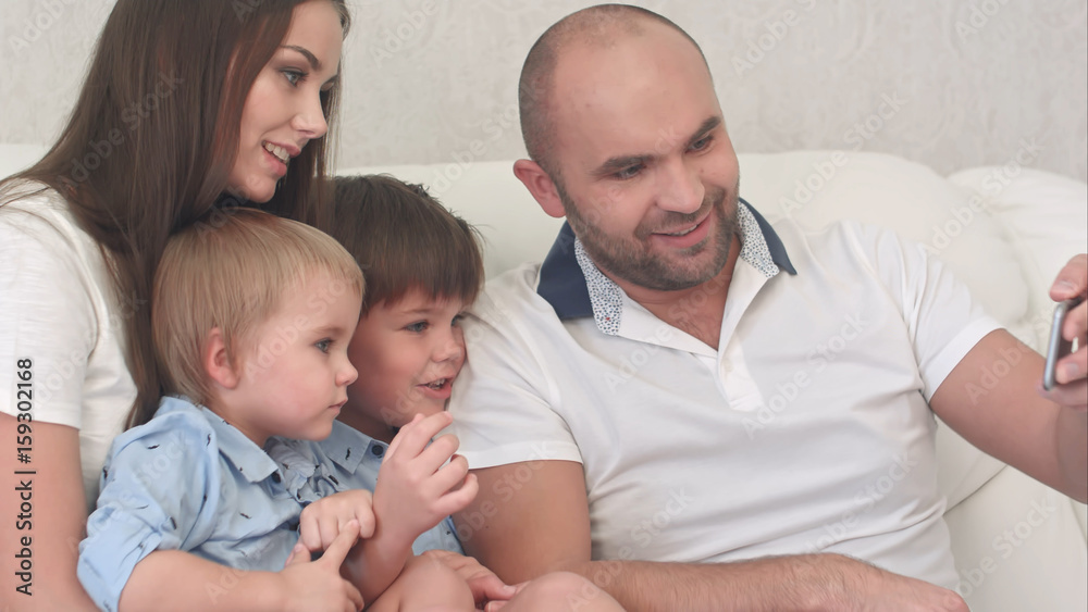 Happy family looking at their photos on the phone