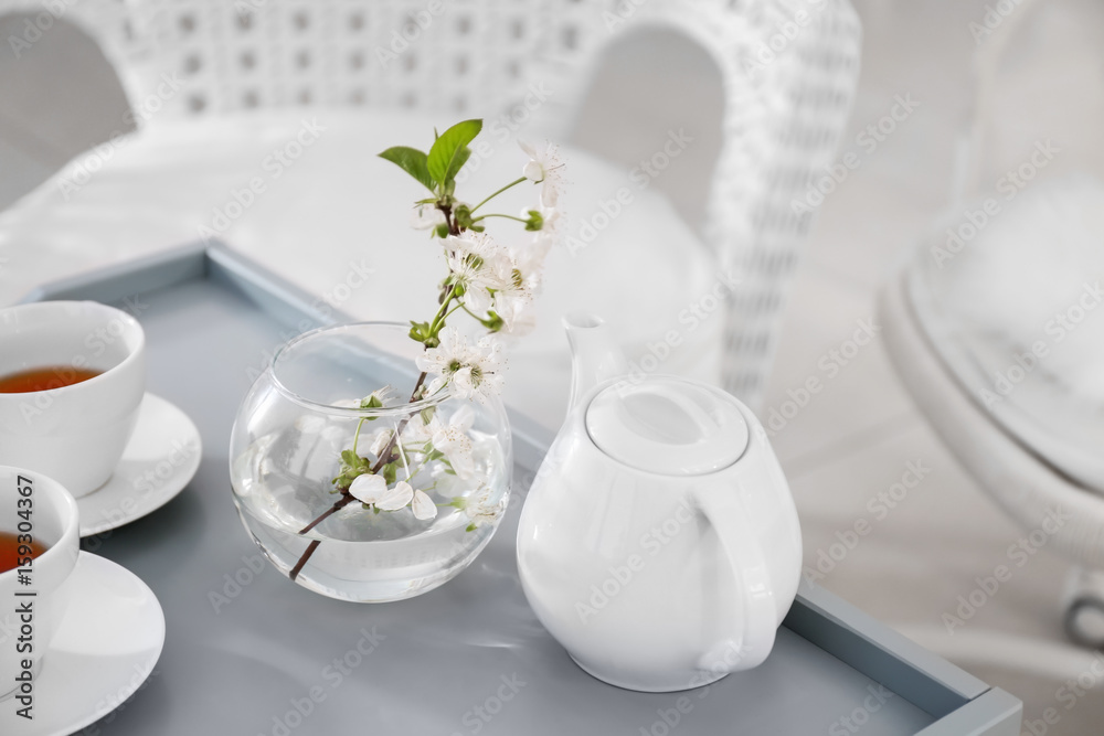 Tea set and beautiful flowers on table at home Tea set and beautiful flowers on table at home