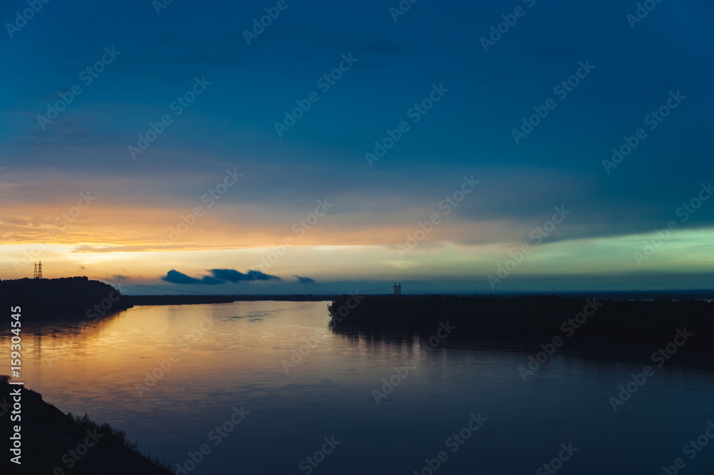Colorful bright sunset landscapes of the Altai Territory. Sunset reflected in the river Ob.