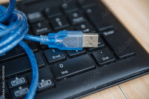 closeup  USB cable on keyboard . Technology concept.
