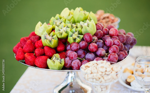 Wallpaper Mural Fresh fruits on plate. Strawberries, kiwi, grapes on catering banquet table. Selective focus Torontodigital.ca