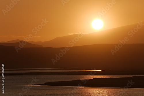 Sunset with Lake and Hilly Landscape