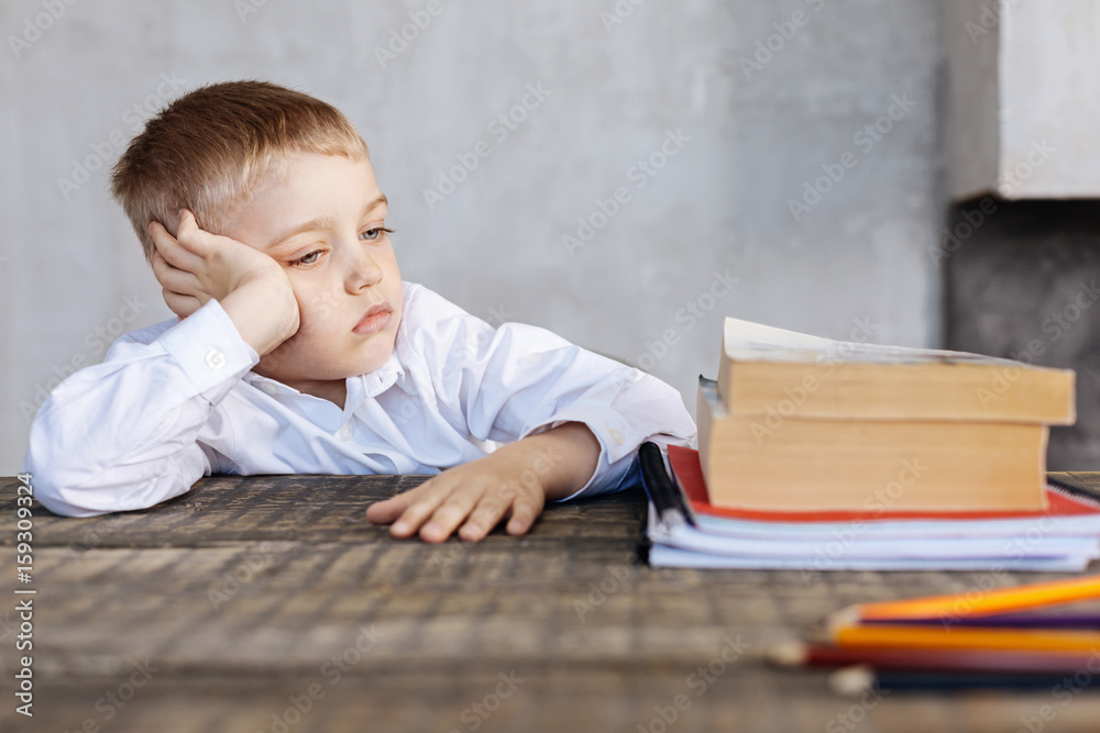 Tired kid not very enthusiastic about studying Tired kid not very enthusiastic about studying
