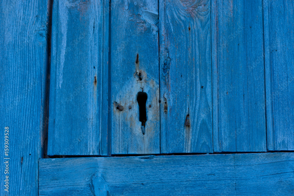 Old bright blue wood door with lock