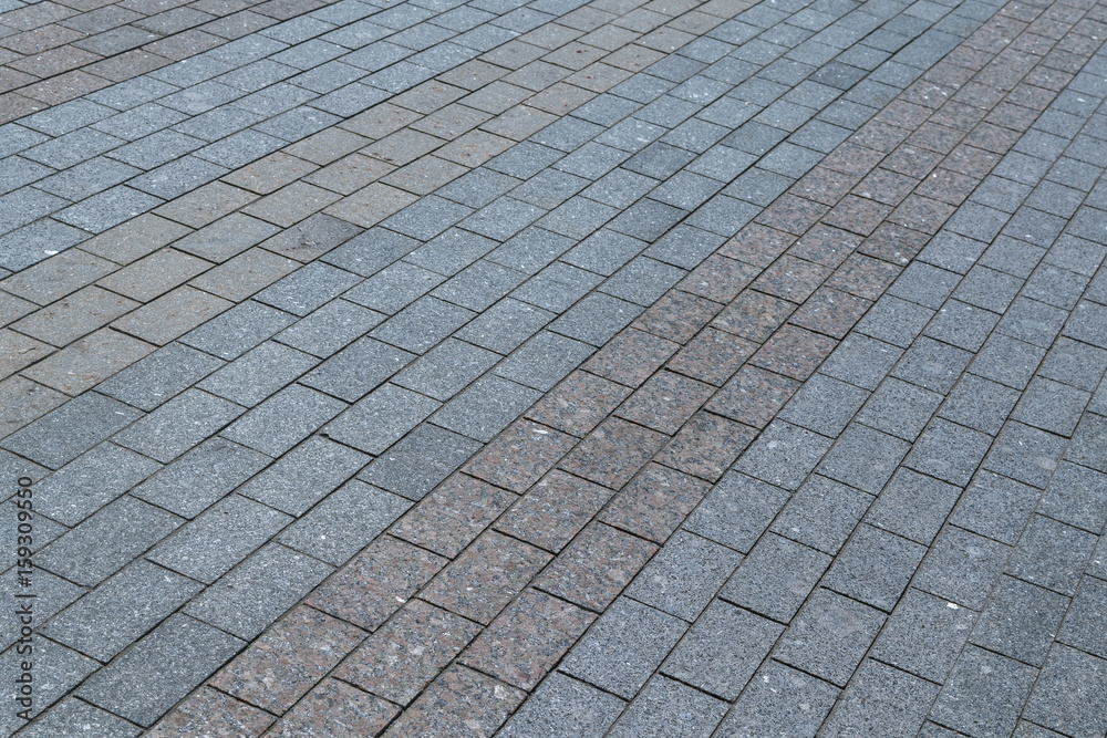 Area or walkway made of granite or marble rectangular tiles grey and brown.