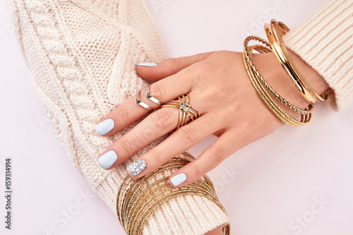 Close-up of female jewelry on hands.