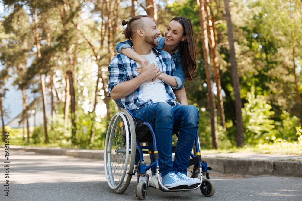 Smiling disabled man looking at his girlfriend Smiling disabled man looking at his girlfriend