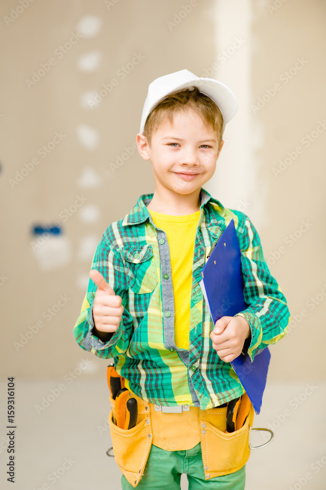 Happy boy with a toolbelt and clipboard showing thumbs up Happy boy with a toolbelt and clipboard showing thumbs up