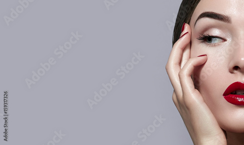 Photography Beautiful young attractive girl close-up half face in a frame, on a gray background in the studio