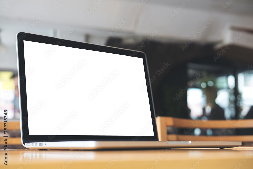 Mockup image of laptop with blank white screen on wooden table in coffee shop Mockup image of laptop with blank white screen on wooden table in coffee shop