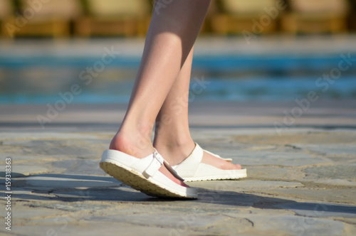 Sandals in front of a pool