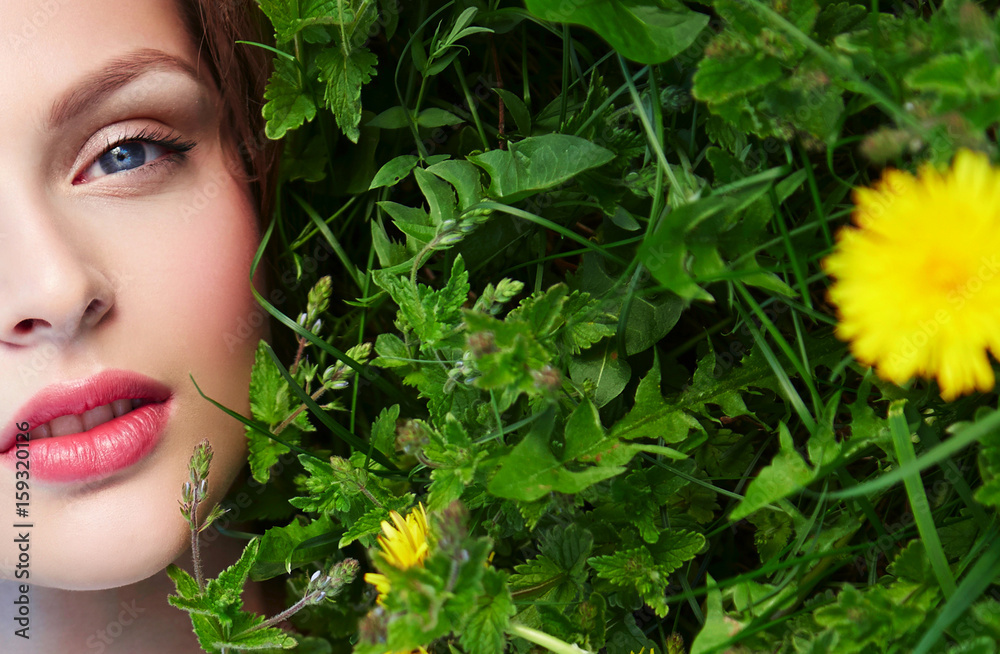 Beautiful young natural well-groomed girl lies on the grass with yellow ...