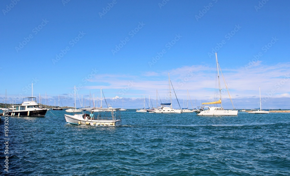 Sail boats on the ocean and a beautiful blue sky background