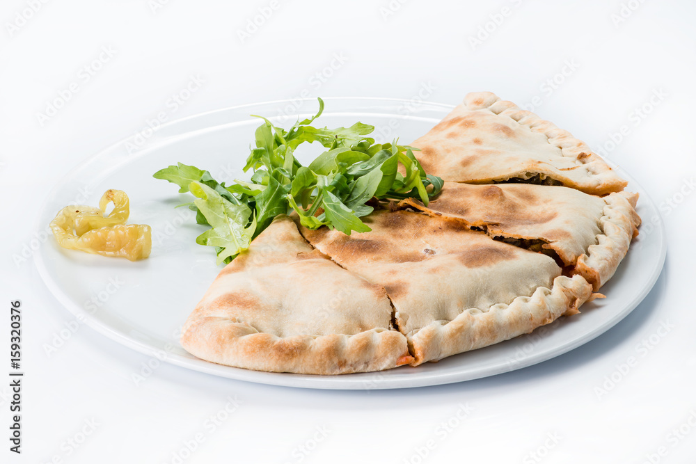 Sliced pizza Calzone on a plate