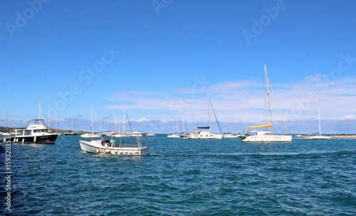 Sail boats on the ocean and a beautiful blue sky background © crlocklear