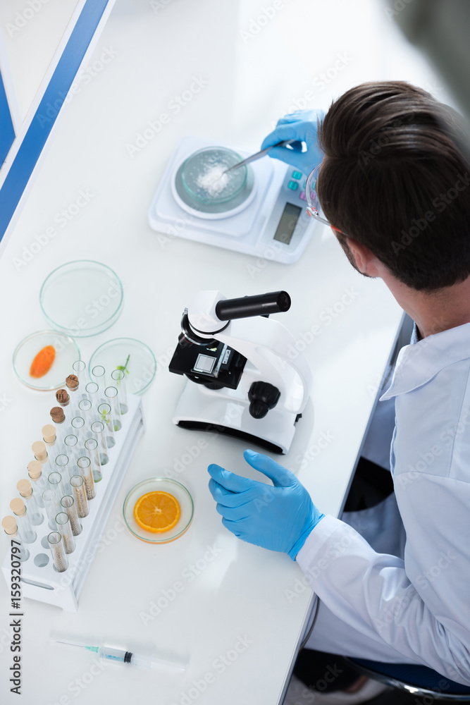 Fototapeta premium Male scientist during work at modern biological laboratory