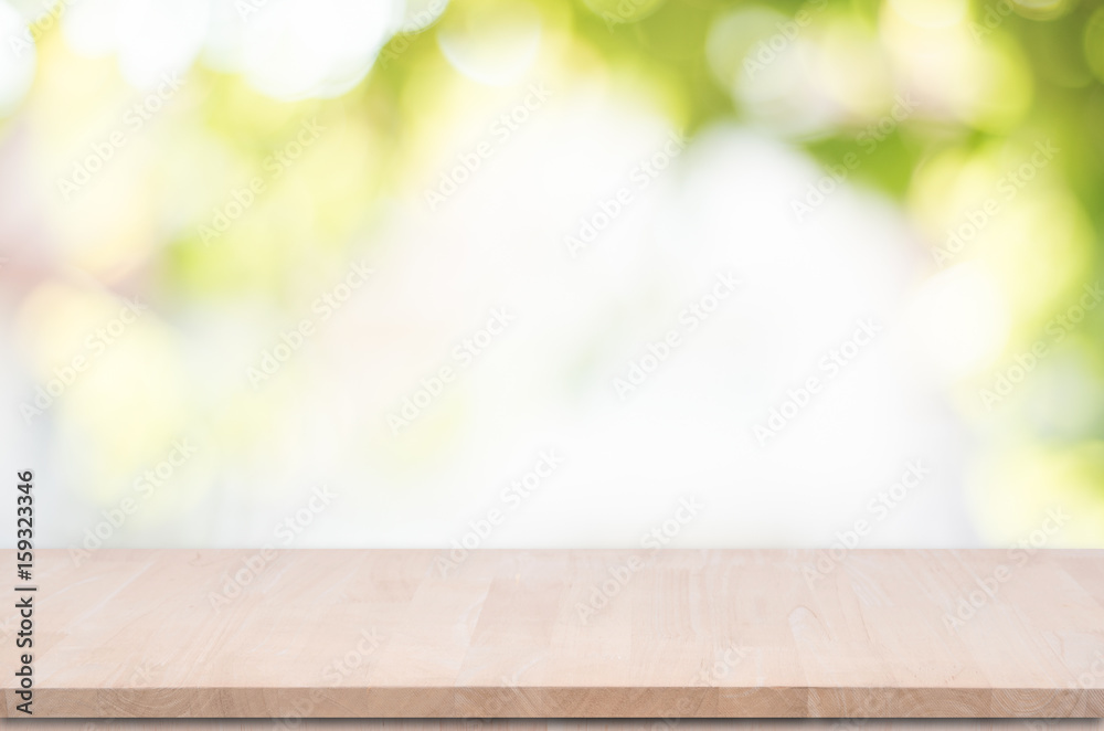 Wood table top on green bokeh background for product display montage.