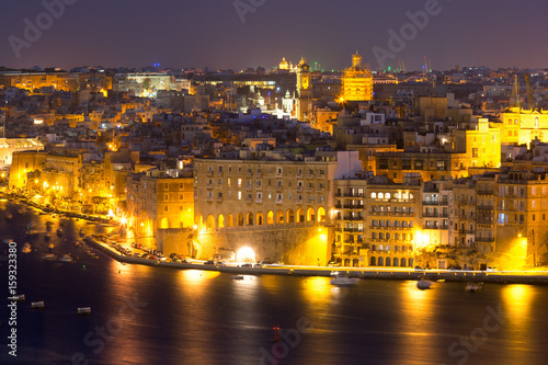 Fototapeta Naklejka Na Ścianę i Meble -  Skyline aerial view of Senglea peninsula as seen from Valletta at night, Malta.
