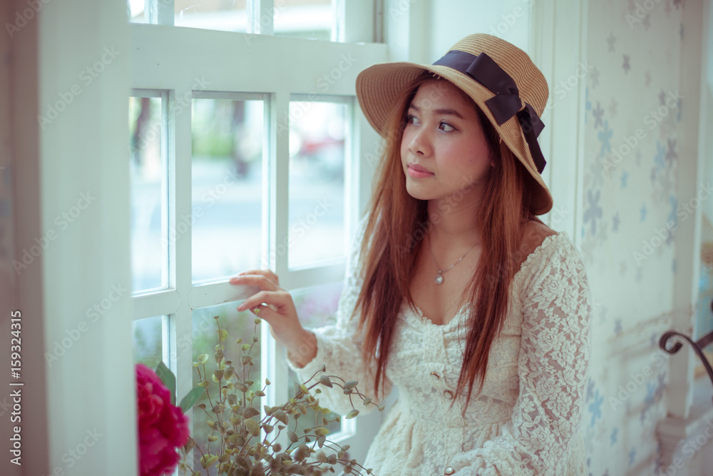 Sad asian vintage woman on the window