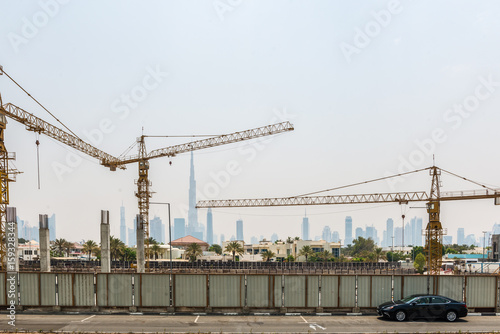 Construction Cranes and Hazy Dubai City Skyline