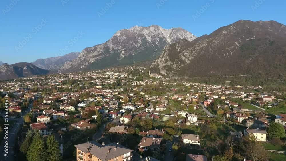 Flight over a town next to Alps in Northern Italy Flight over a town next to Alps in Northern Italy