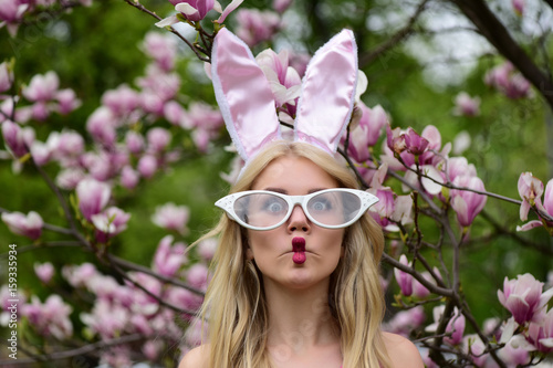 Pretty girl making fish face in glasses and bunny ears