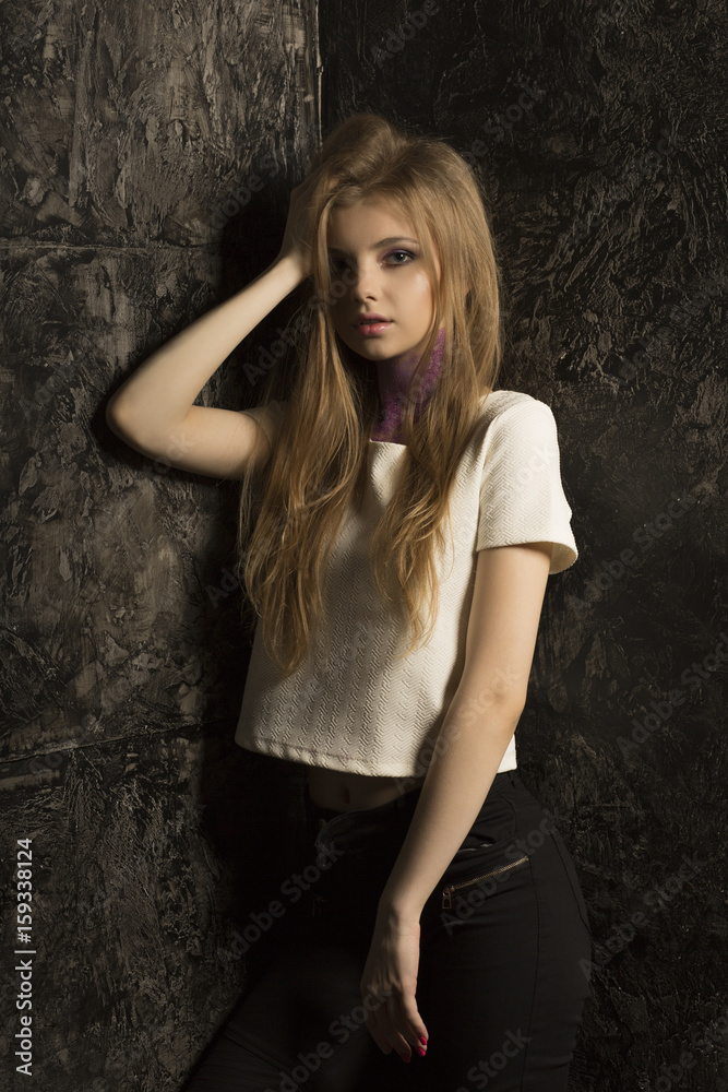 Fototapeta premium Portrait of young awesome model with bright makeup and glitter on her neck