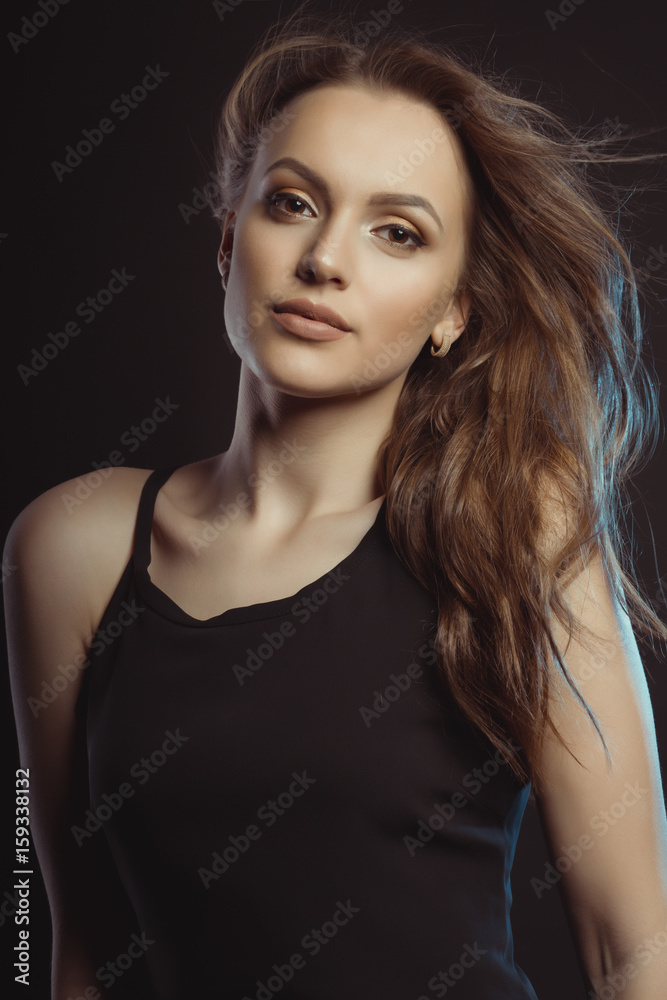 Closeup photo of beautiful young model with curly hair in motion Closeup photo of beautiful young model with curly hair in motion
