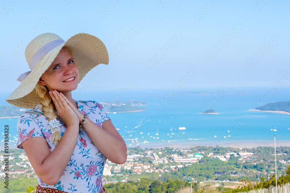 A young attractive woman on background Bay on the island of Phuket, Thailand while traveling across Asia on holidays