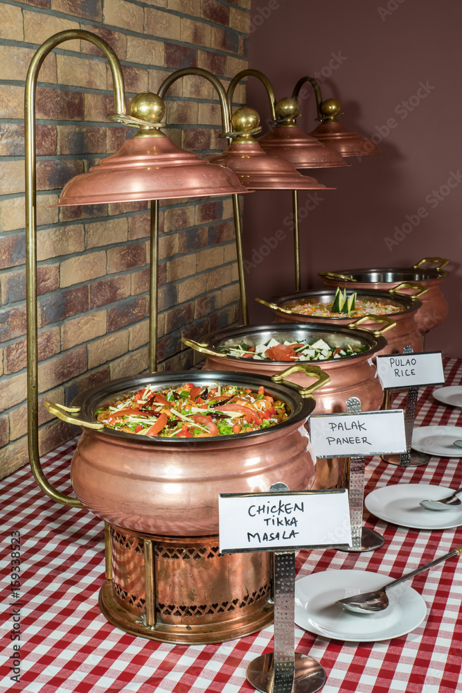 Indian lunch buffet or catering table with traditional brass copper