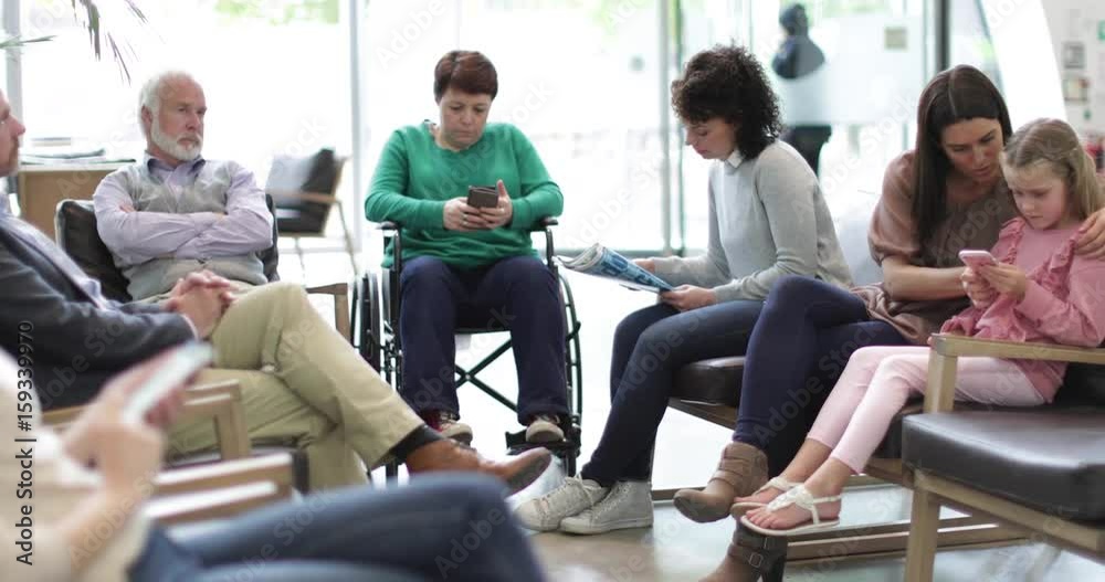 Patients waiting to be called in a crowded hospital waiting room 