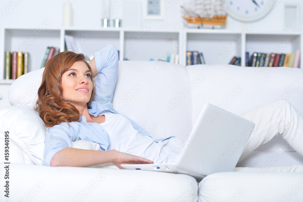 Young woman lying with laptop Young woman lying with laptop