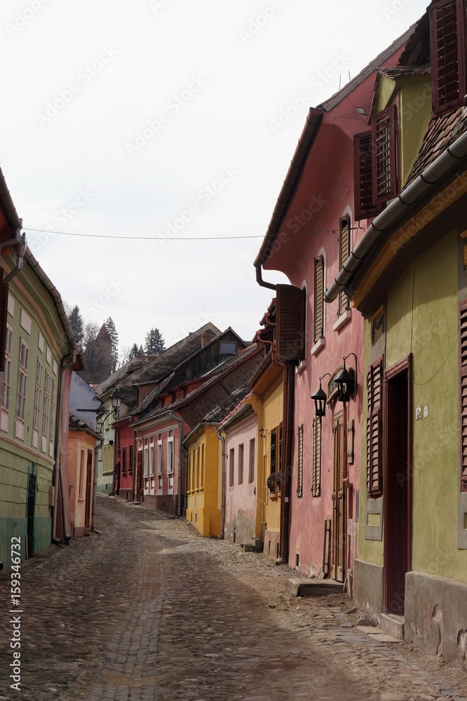 Street of Sighisoara with its colorful houses, village of Transylvania, Romania 