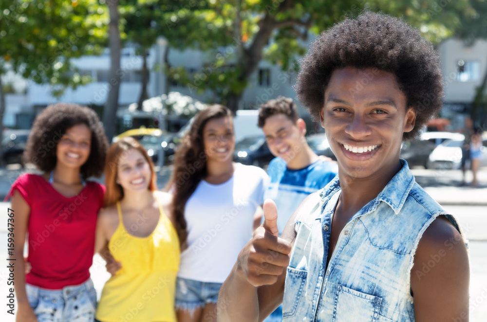 Obraz premium African american guy showing thumb with group multi ethnic people