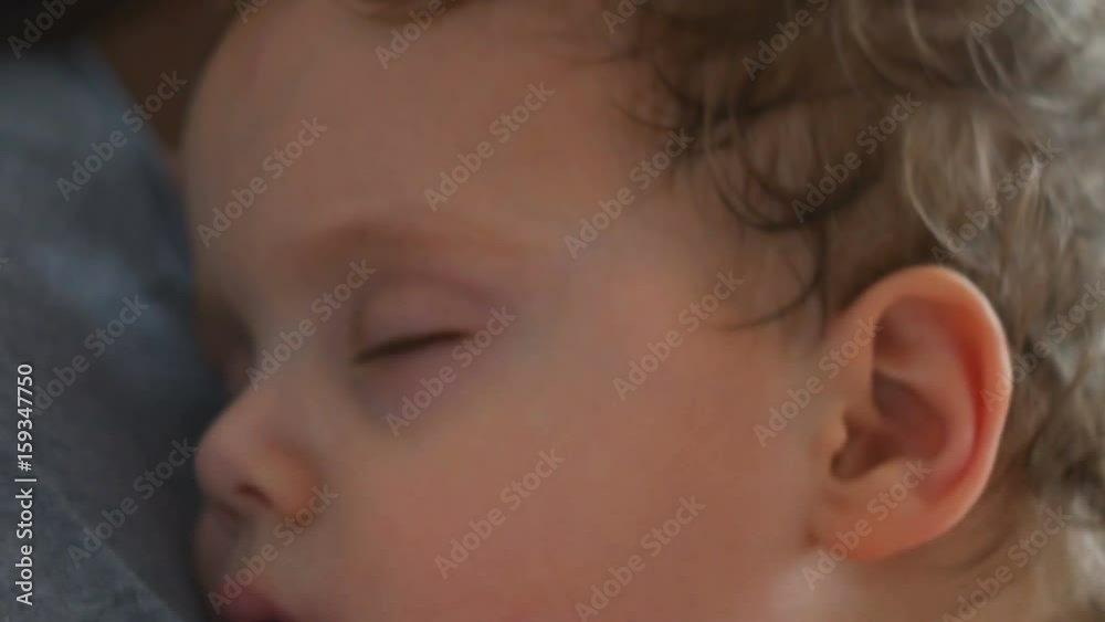 Mother and her little baby boy in bed in sunny room Mother and her little baby boy in bed in sunny room