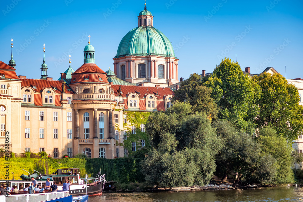 Naklejka premium St. Francis of Assisi Church viewed from across the Vltava river. Prague, Czech Republic