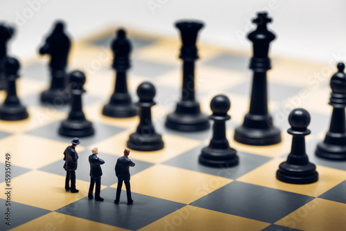 Businessmen on a chessboard. Business strategy concept photo