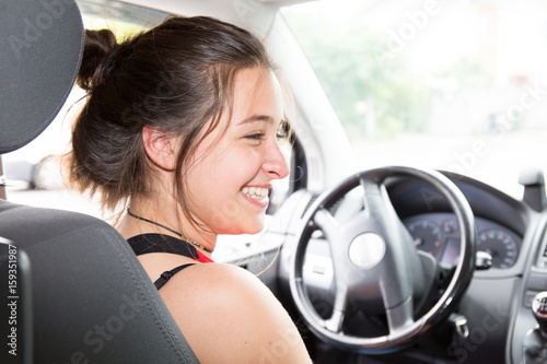 back view of girl in car happy and smile