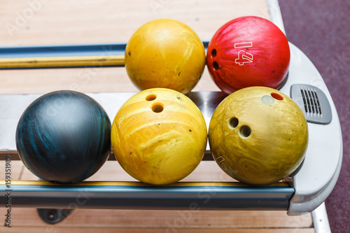 Set of bright colorful bowling balls waiting for player