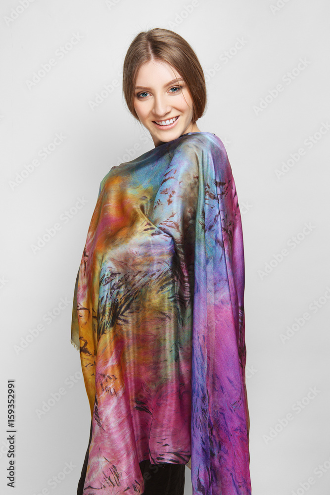 Attractive girl in slim dress and colorful silk scarf posing on white background Attractive girl in slim dress and colorful silk scarf posing on white background