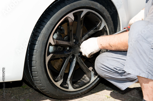 man technician comes to repair a punctured wheel